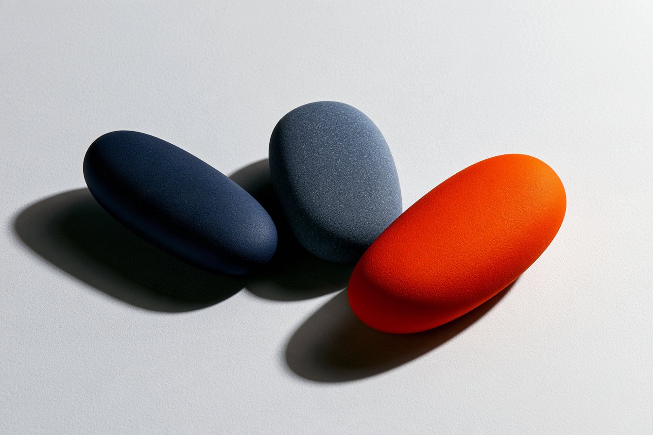 Trois galets inclinés : bleu nuit, bleu ardoise et orange.
